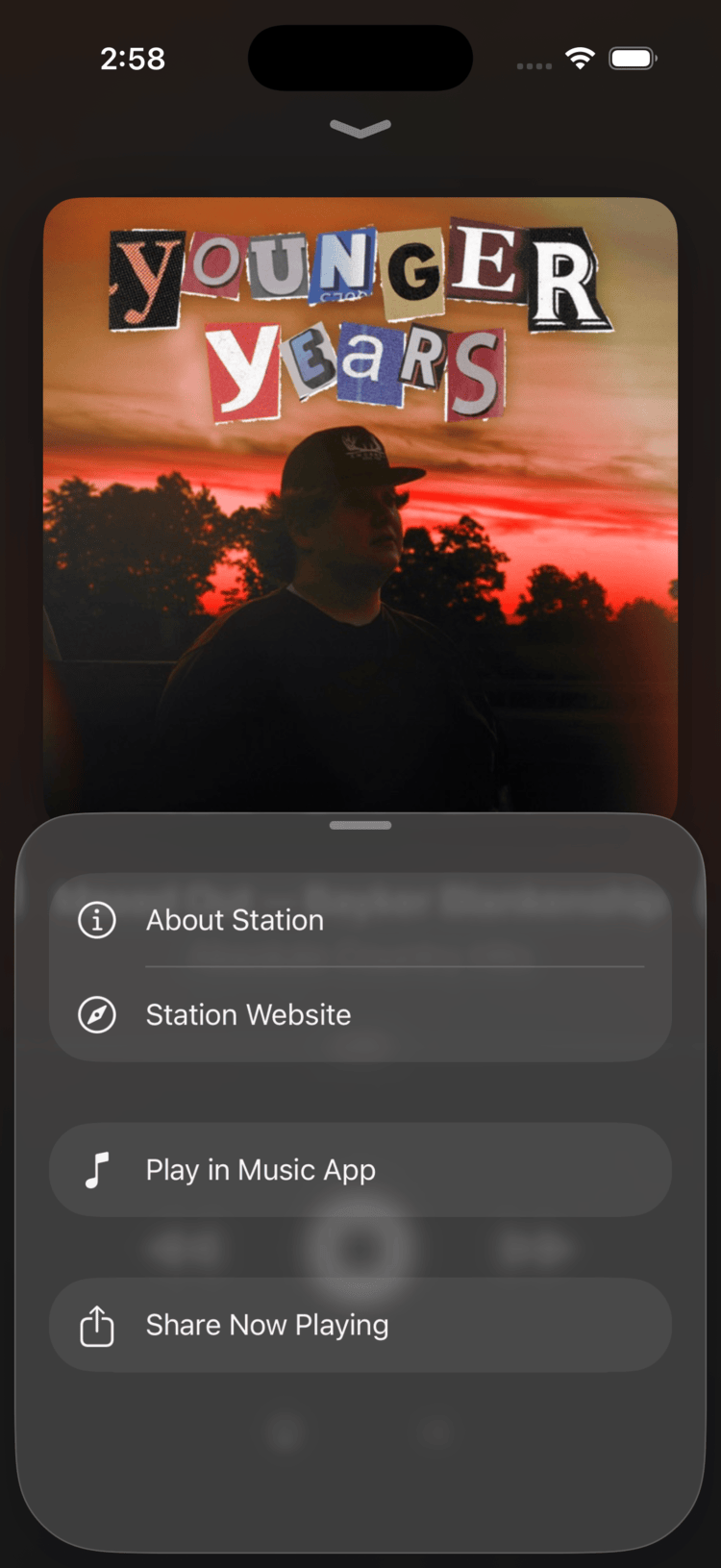 Swift Radio bottom sheet in English showing About Station, Station Website, Play in Music App, and Share Now Playing